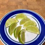 sliced limes on a plate on a wooden table