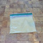 flat freezer bag filled with applesauce on a wooden table