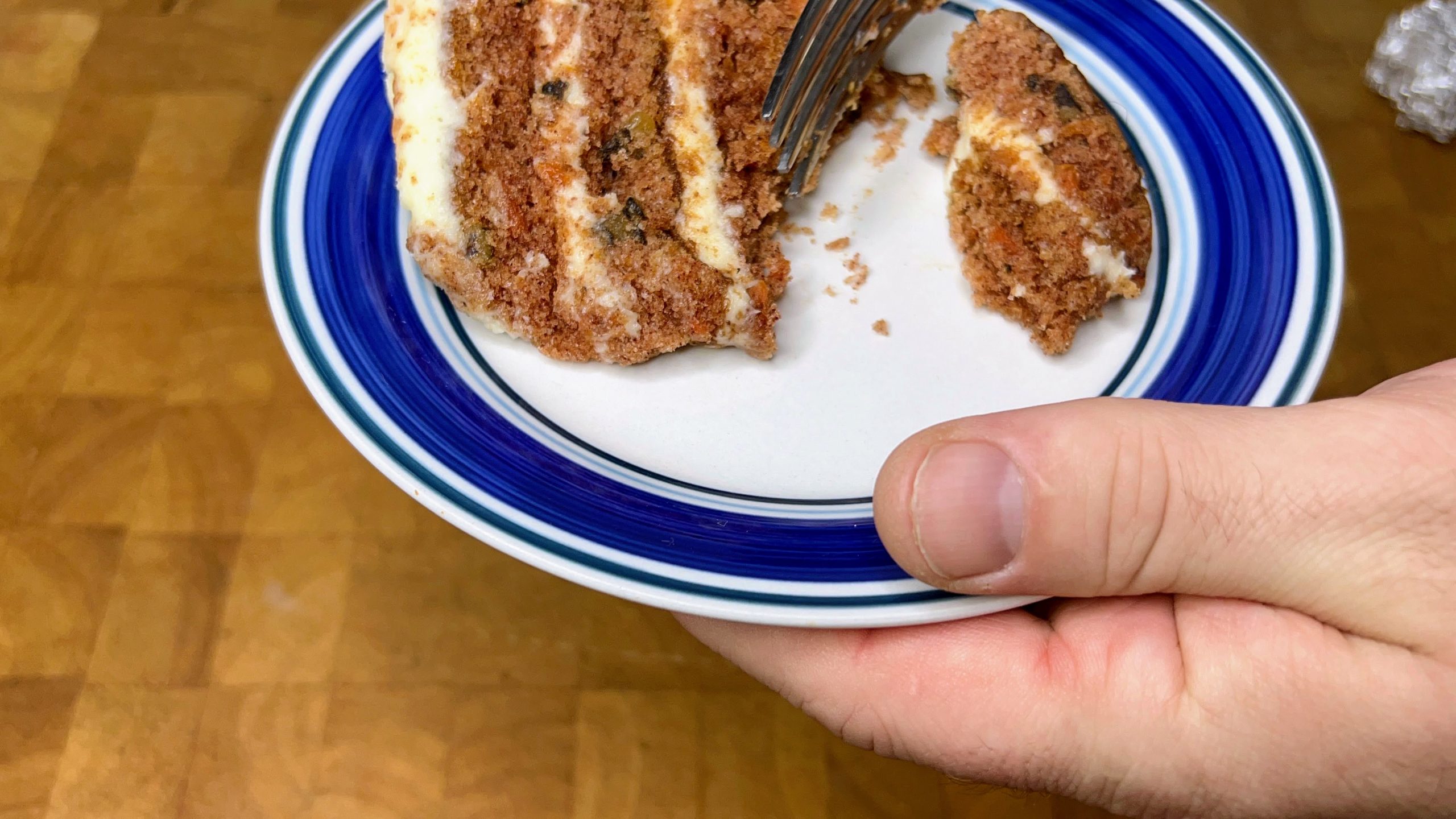 defrosted slice of carrot cake with a bite cut out.