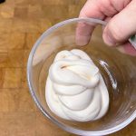 bowl of defrosted cream cheese frosting