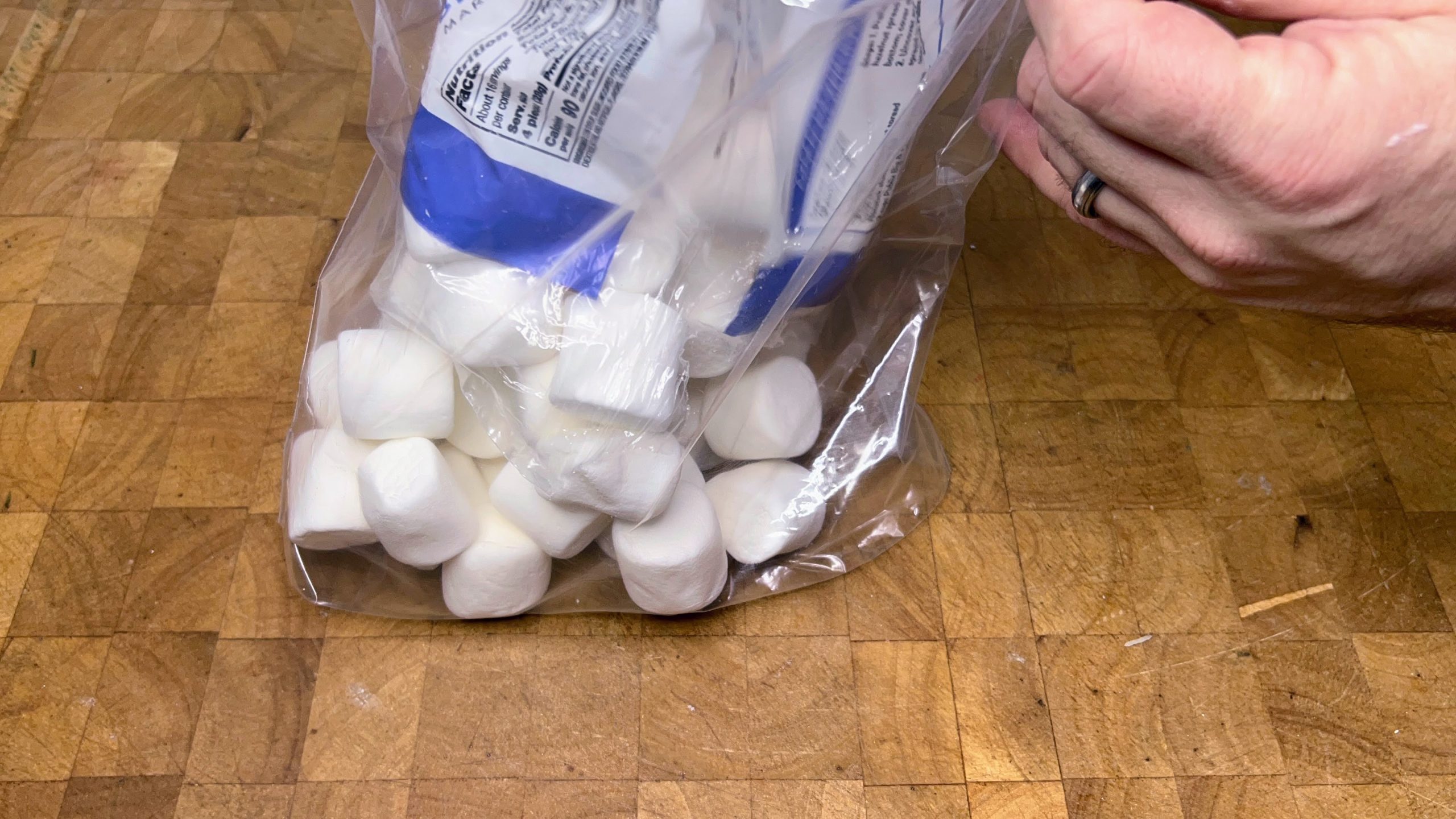pouring marshmallows into a freezer bag 