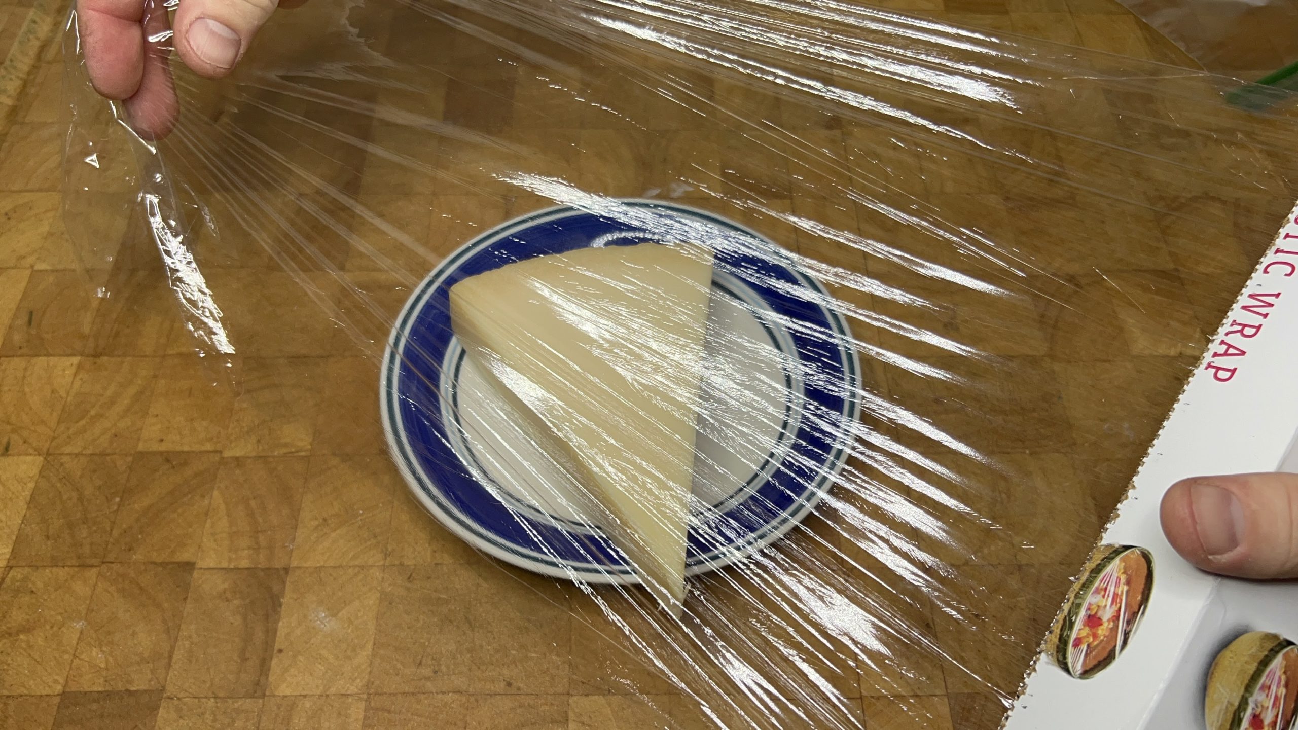 wrapping parmesan cheese with plastic wrap