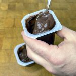 scooping out a spoonful of chocolate pudding