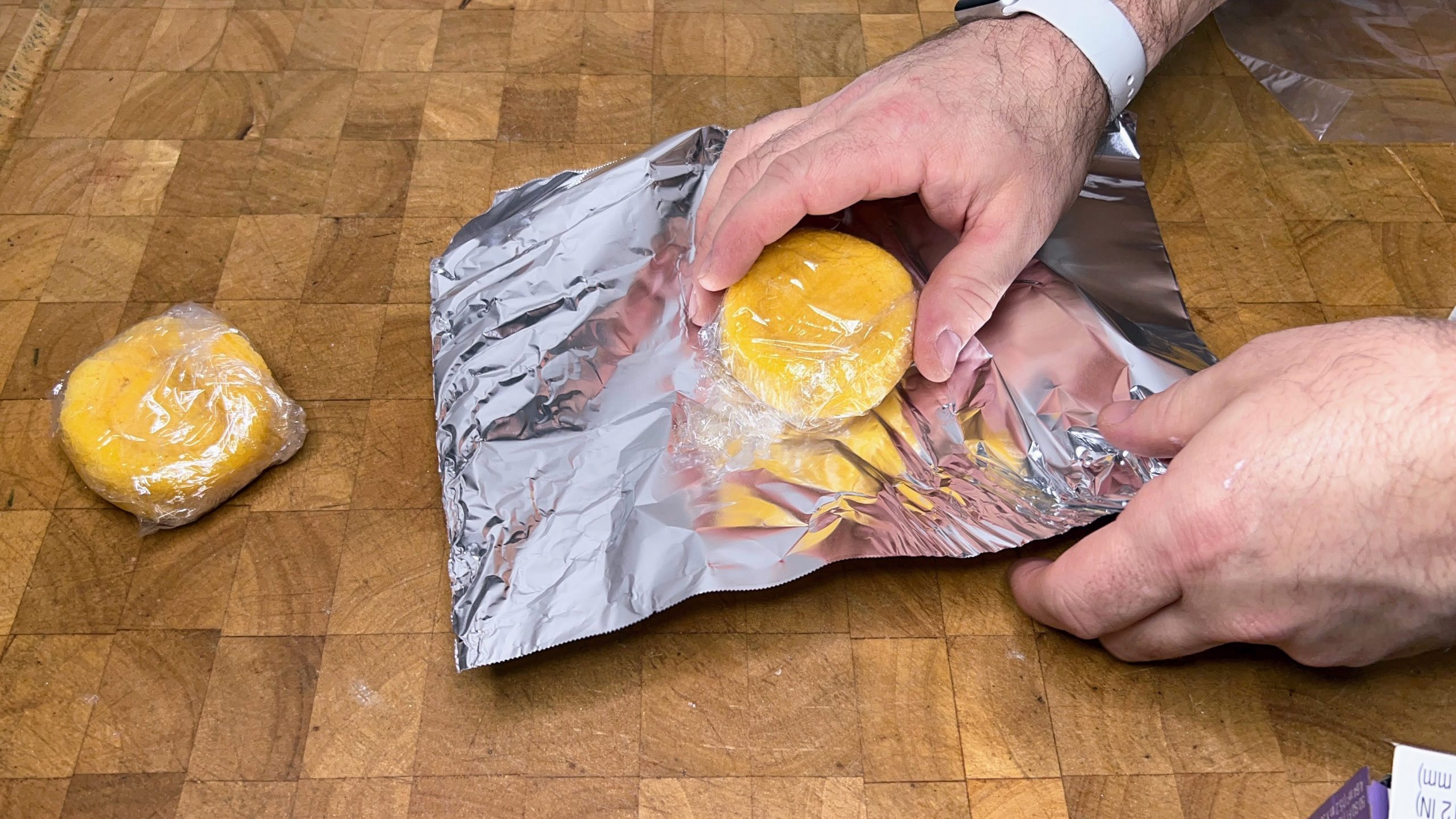 wrapping a slice of sponge cake in aluminum foil