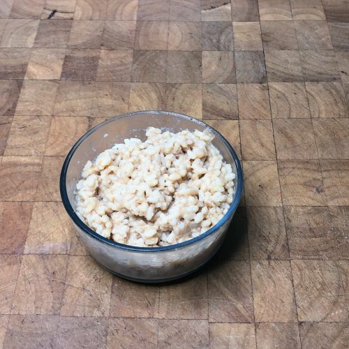 bowl of parmesan risotto on a wooden table