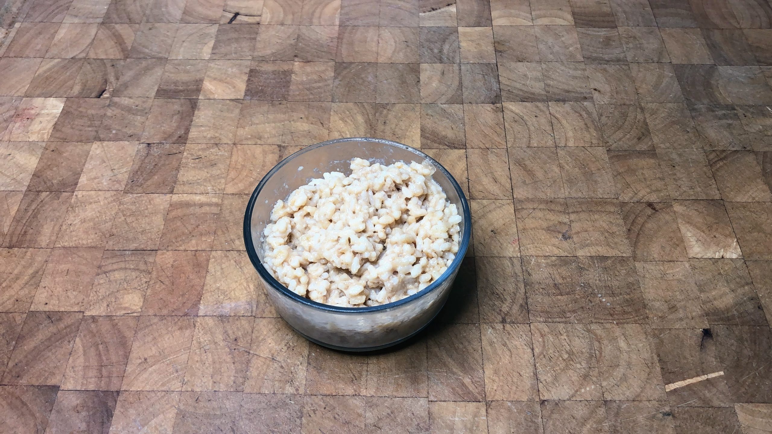 bowl of parmesan risotto on a wooden table