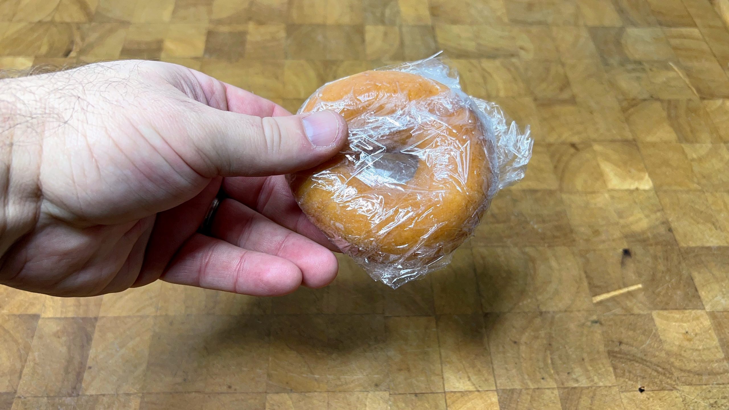 krispy kreme glazed doughnut wrapped in plastic wrap
