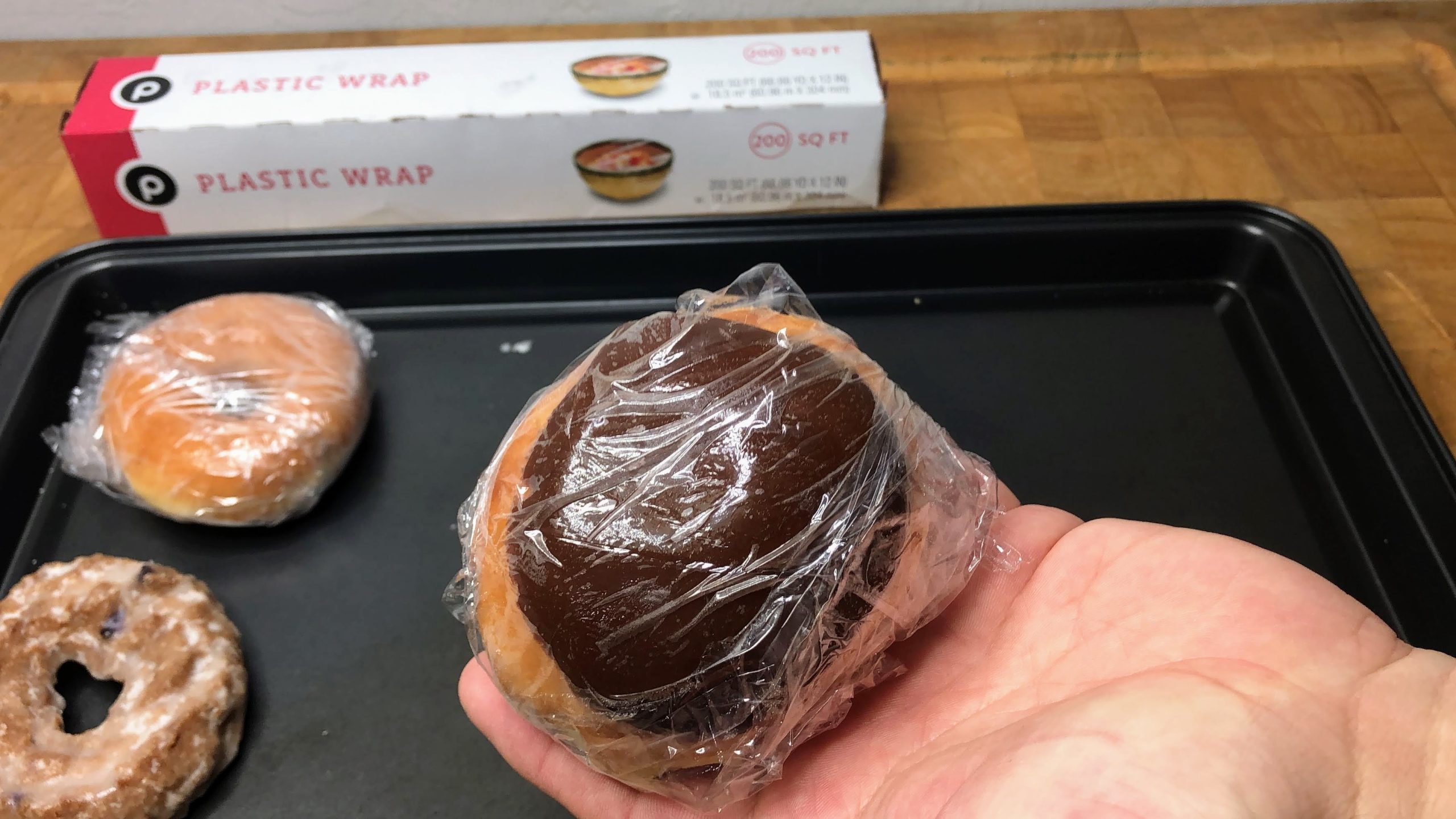 chocolate iced and filled krispy kreme doughnut wrapped in plastic wrap