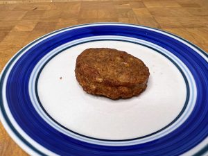 cooked sausage on a blue and white plate