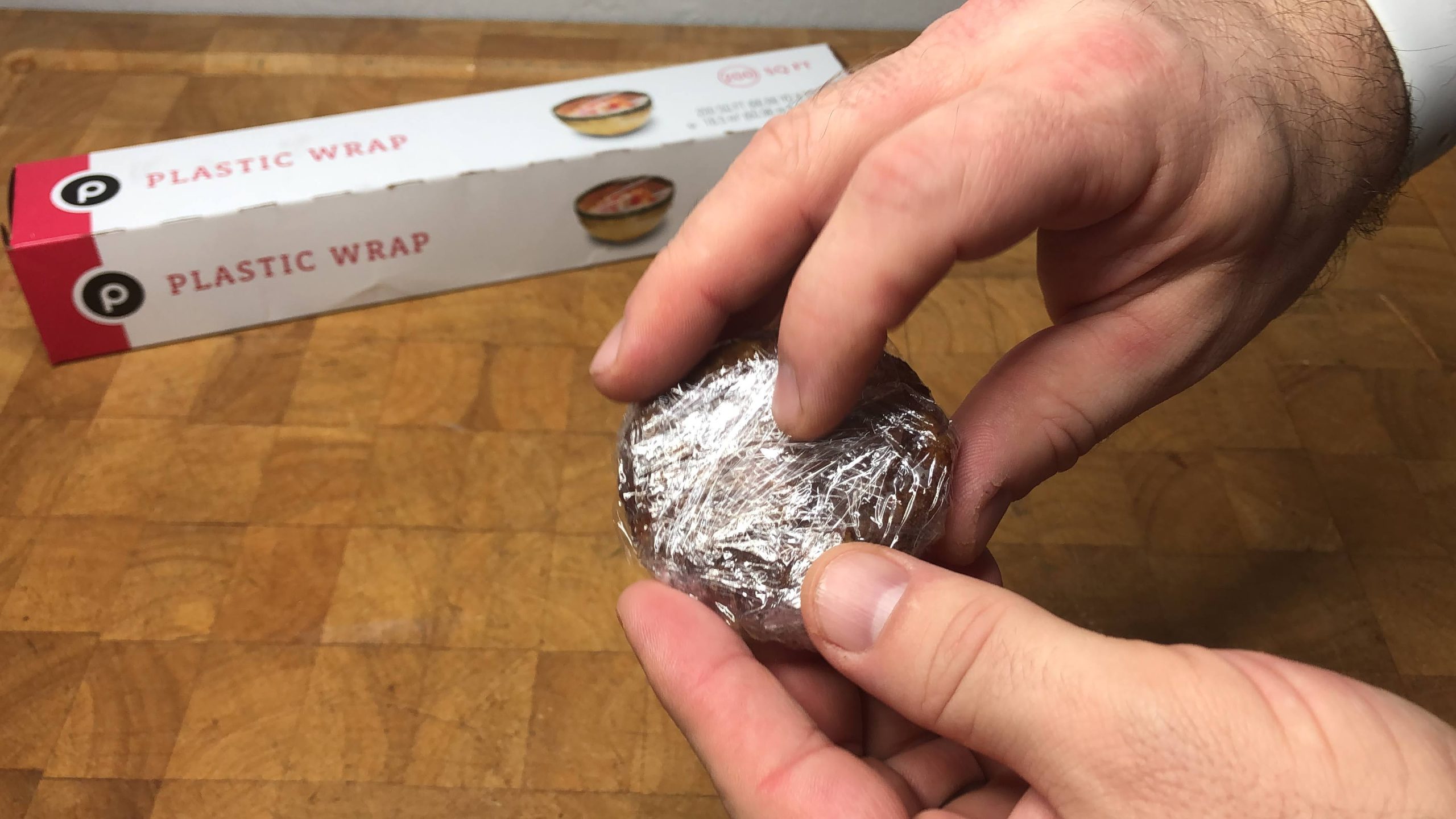 cooked sausage wrapped in plastic wrap
