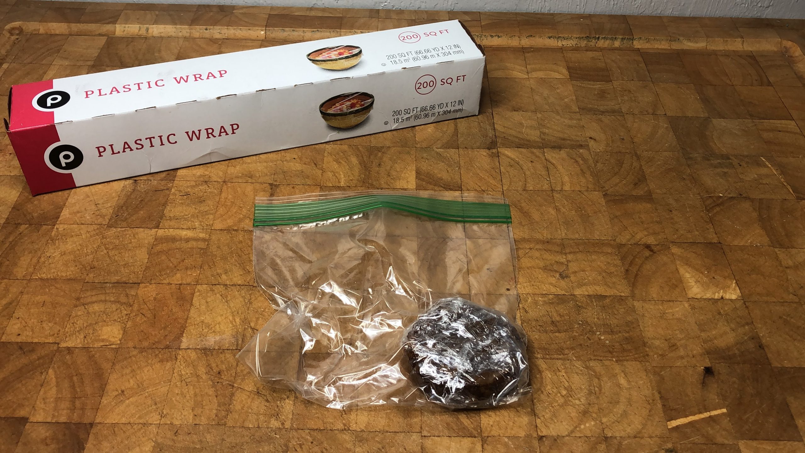 cooked sausage wrapped in plastic wrap and zipped into a freezer bag