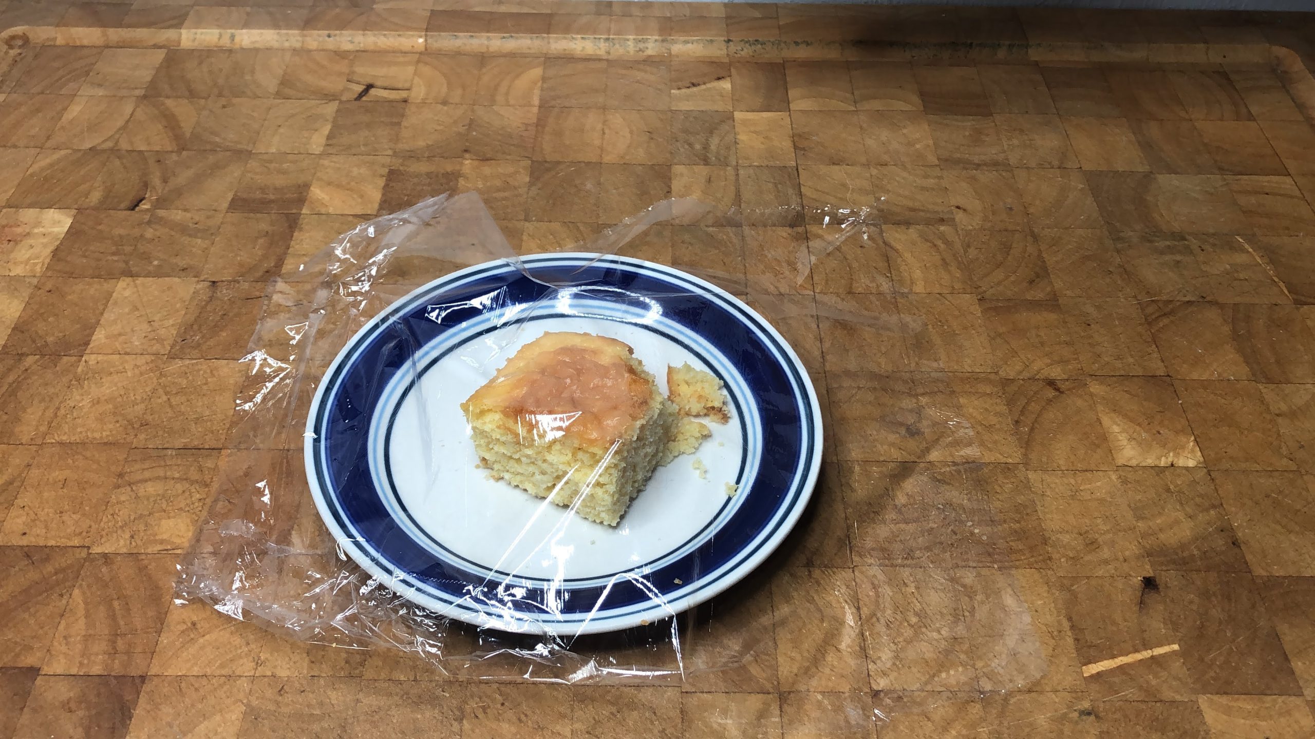 wrapping a slice of cornbread in plastic wrap