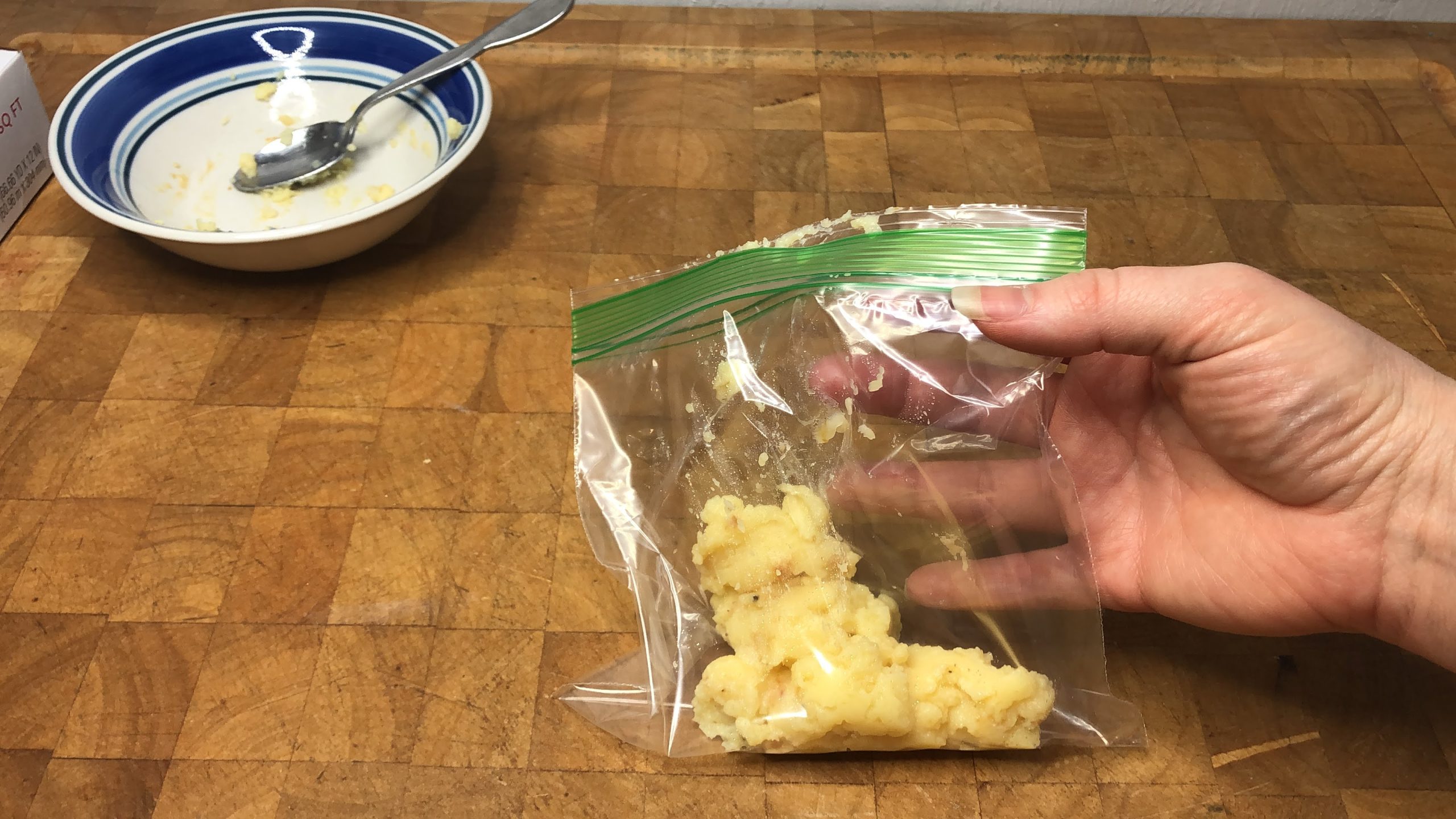 zipping freezer bag of custard shut