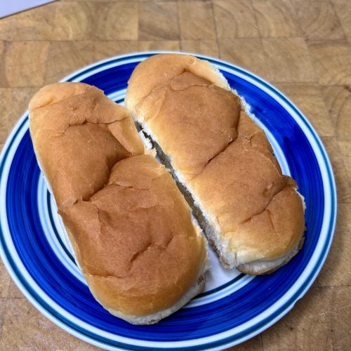 two hot dog buns on a plate