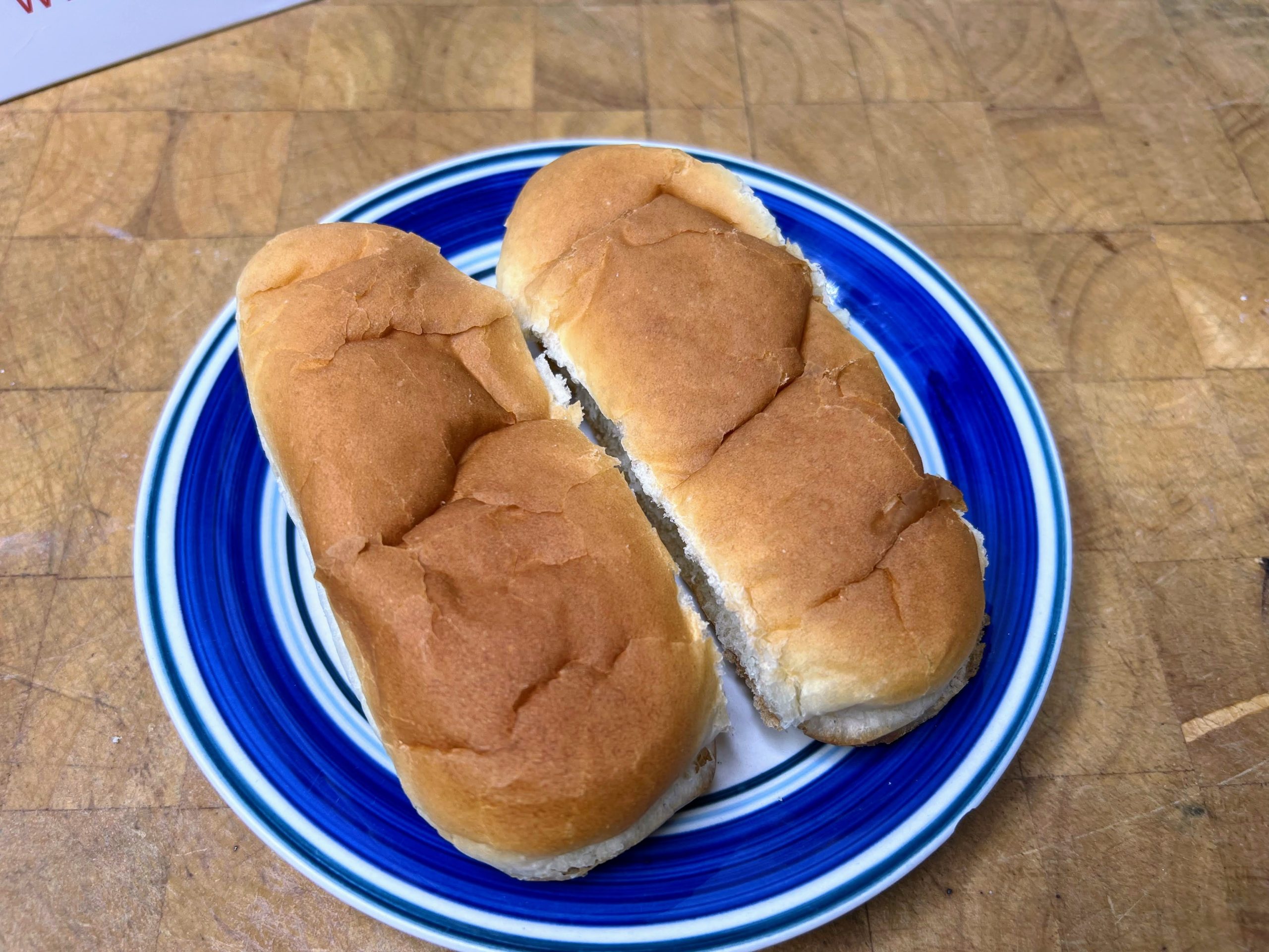 two hot dog buns on a plate