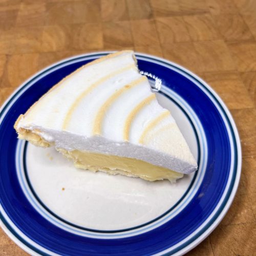 slice of lemon meringue pie on a plaste