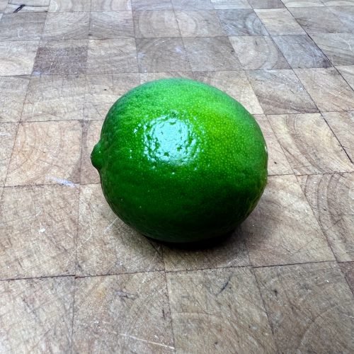 whole lime sitting on a wooden table
