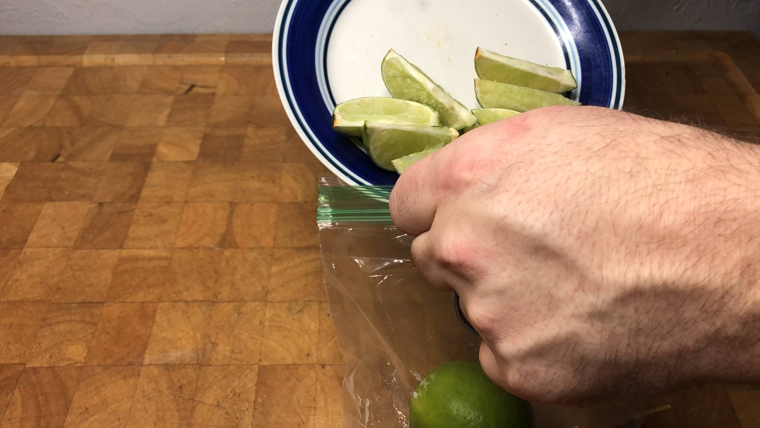 putting lime slices into a freezer bag