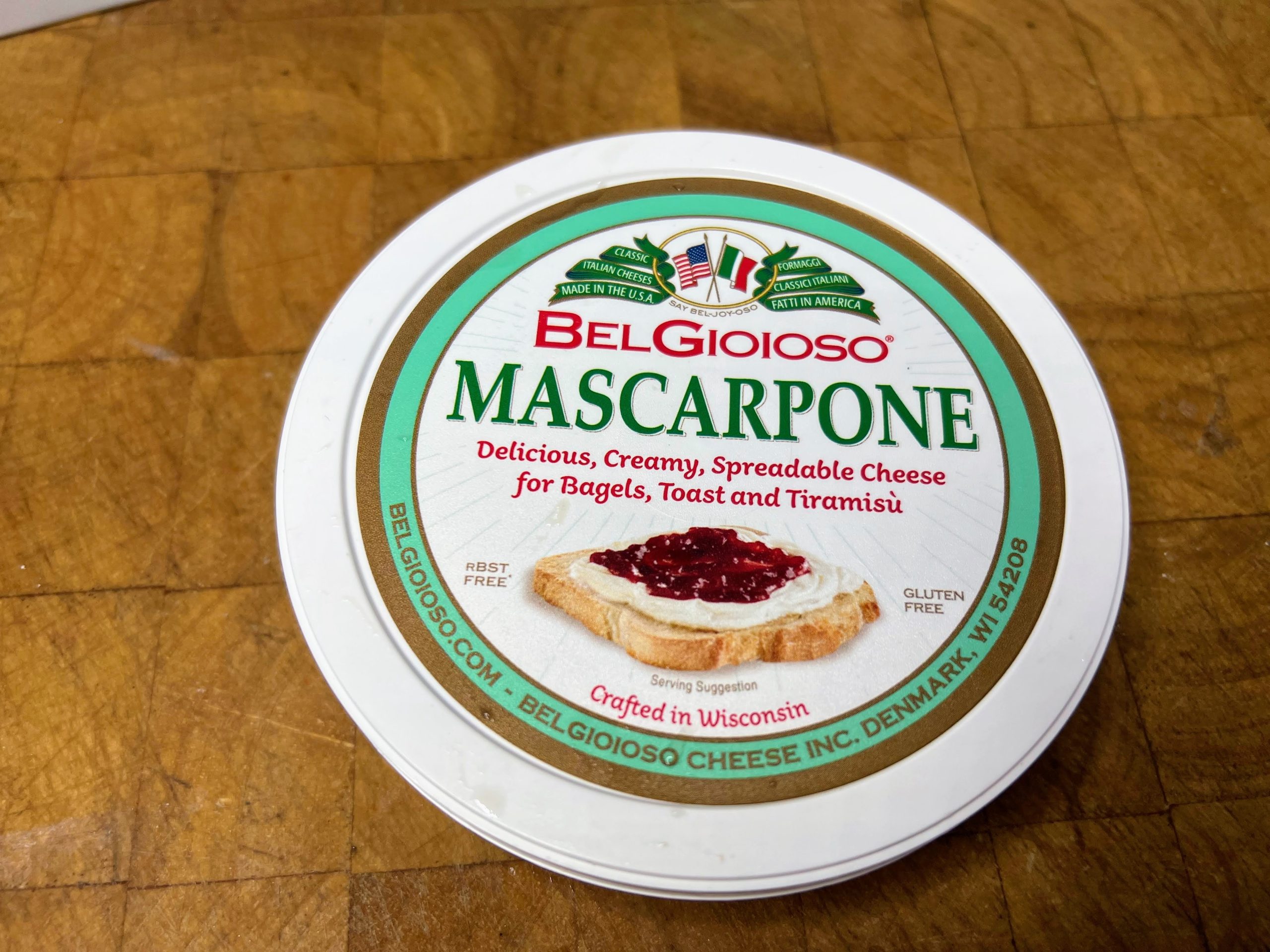 container of mascarpone cheese on a wooden table