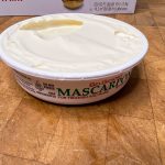 open container of mascarpone cheese on a wooden table
