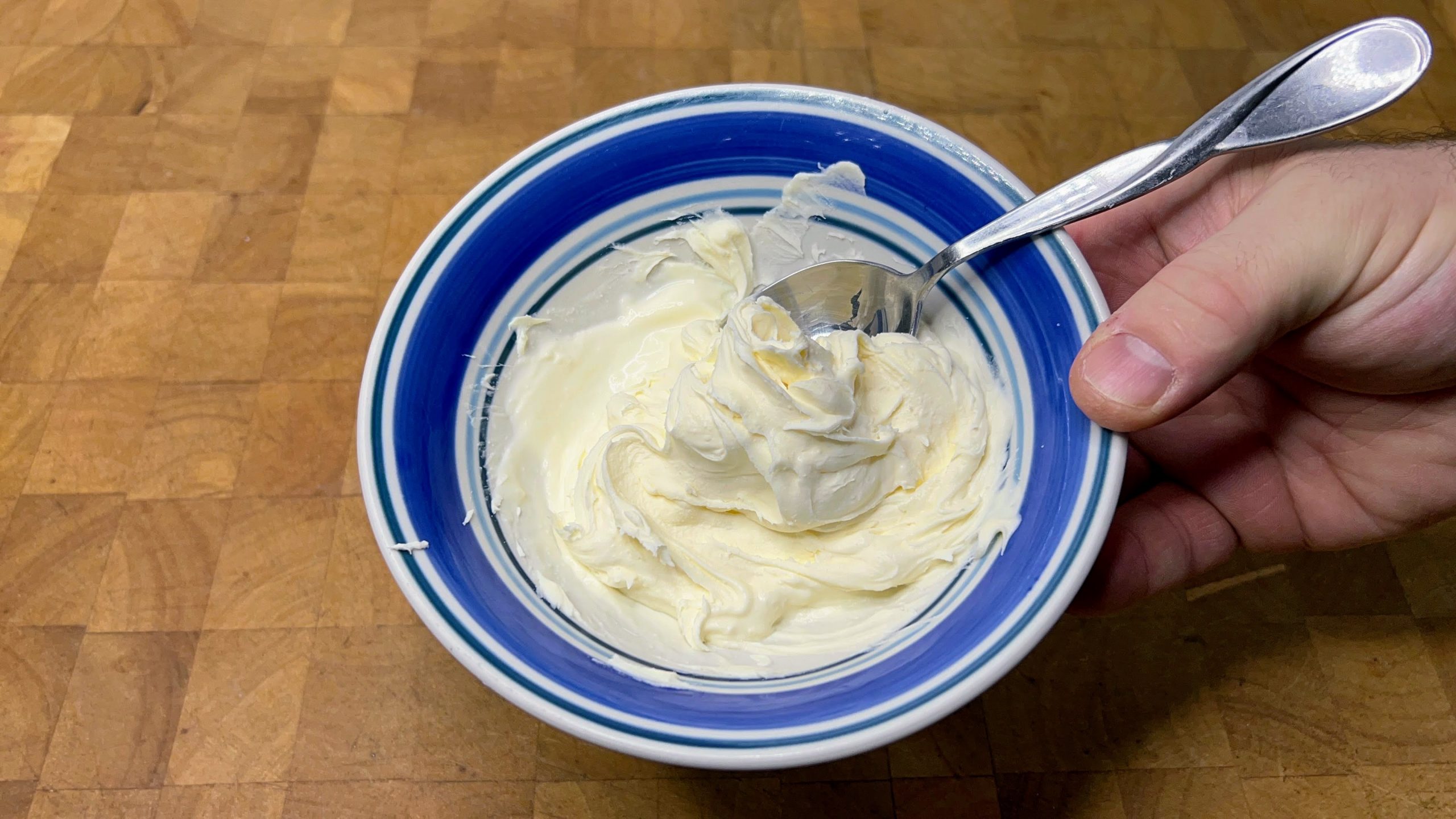 bowl with defrosted mascarpone cheese and a spoon