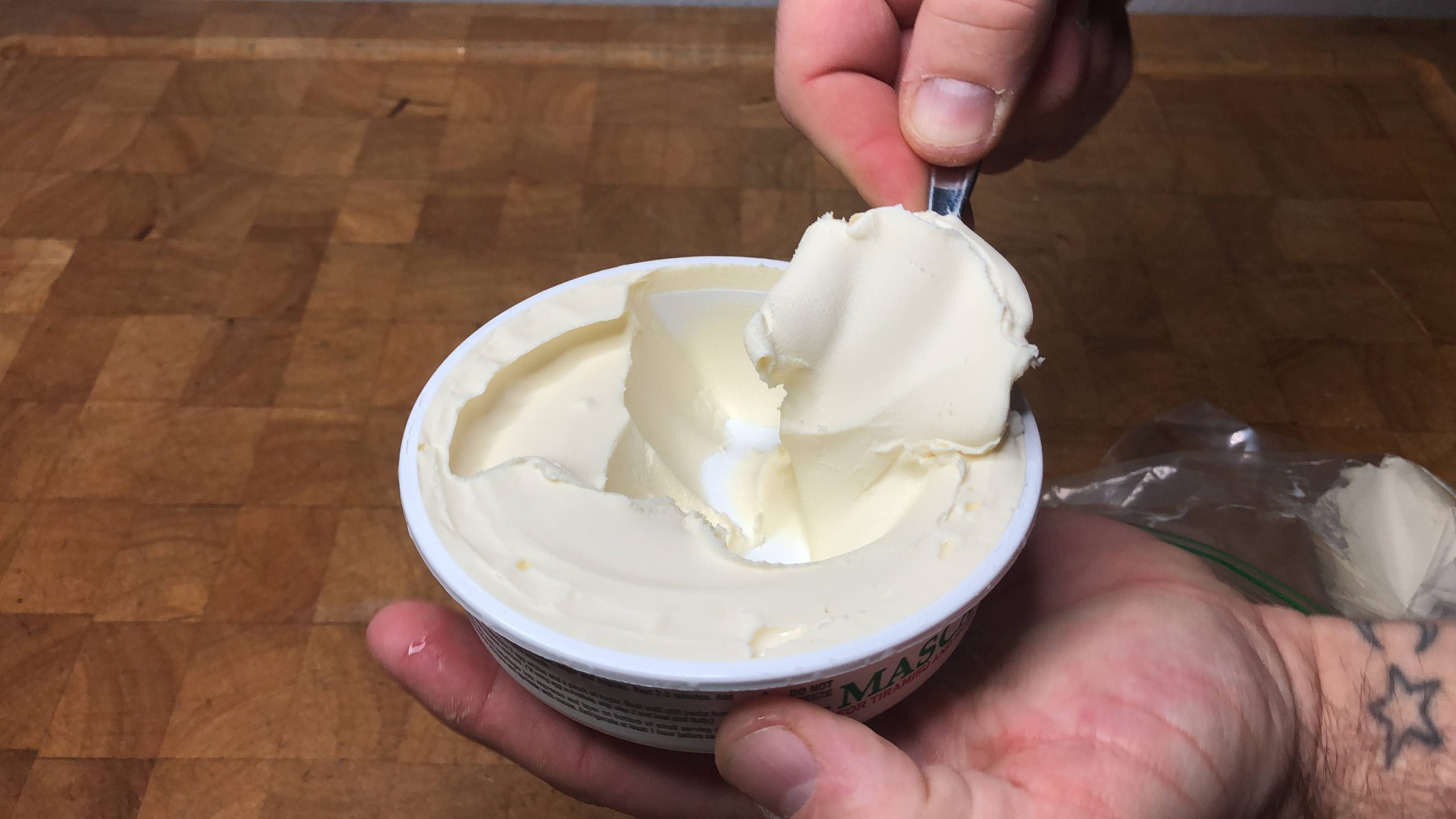 scooping a spoonful of mascarpone cheese