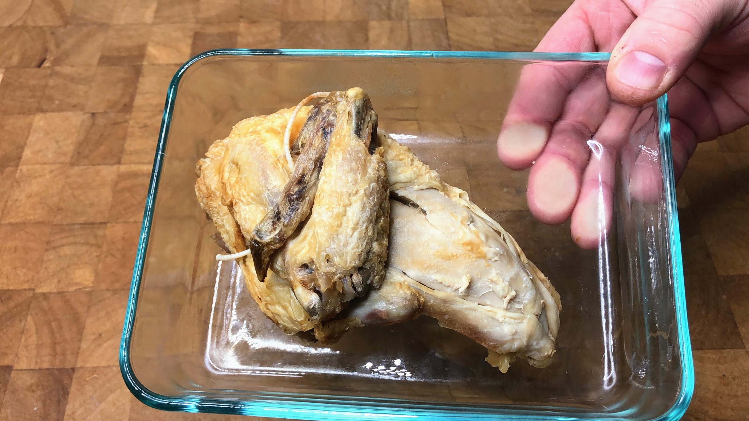 piece of defrosted rotisserie chicken in a pyrex