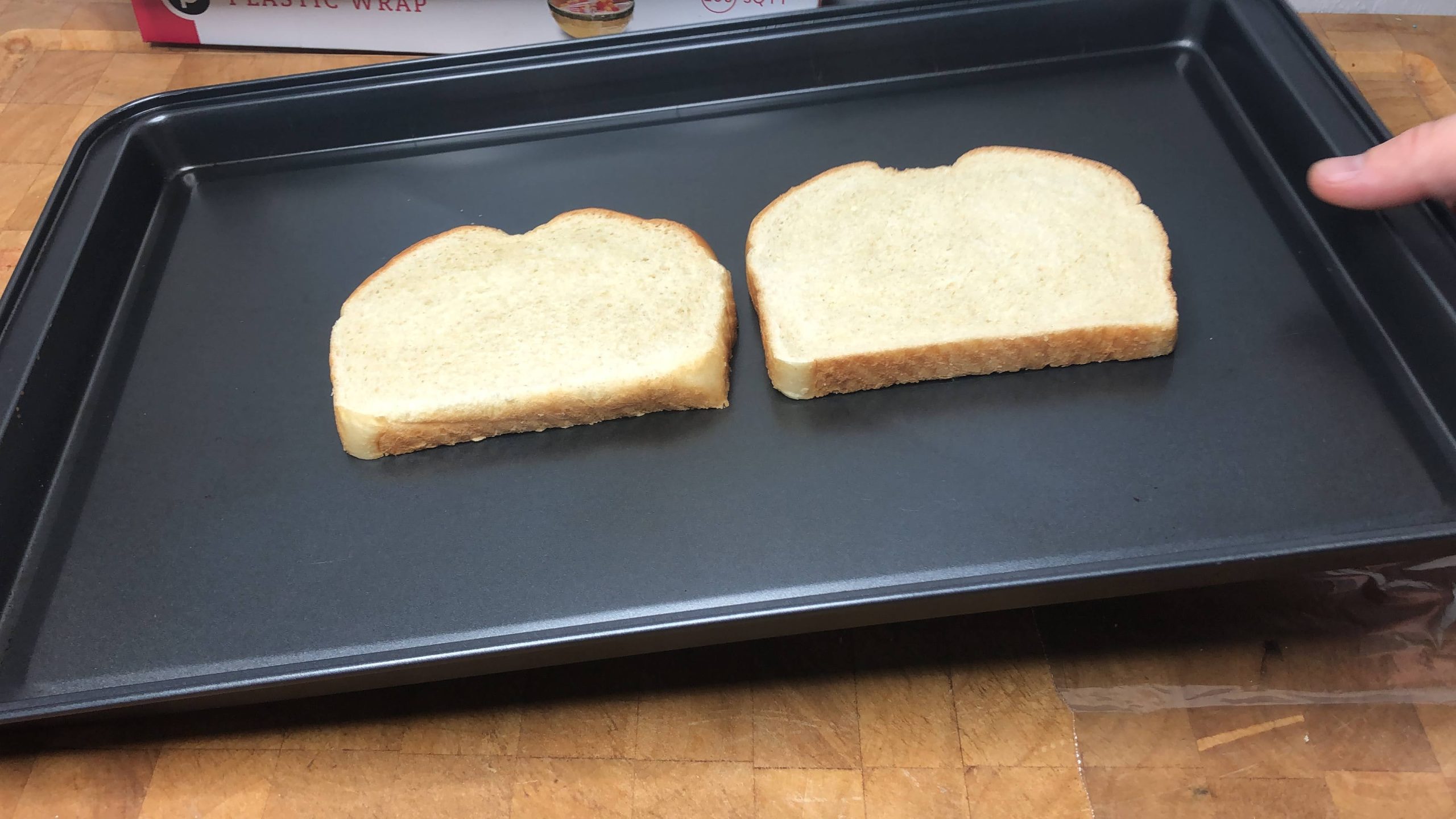 two slices of sourdough bread on a cookie sheet
