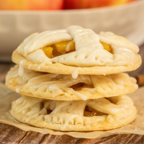 Stack of apple pie cookies on brown paper.