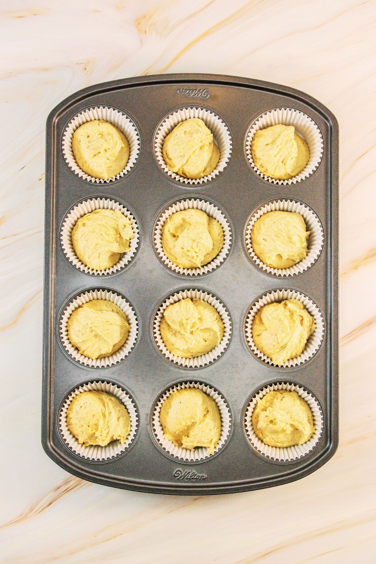 Cupcake batter in cupcake tins.
