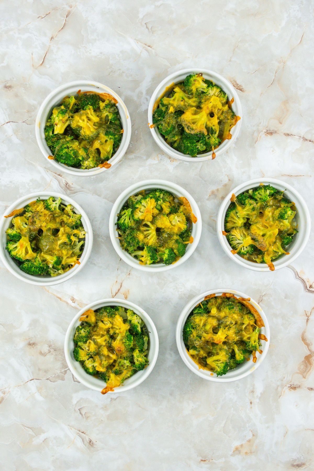Broccoli cheese casseroles on a counter.