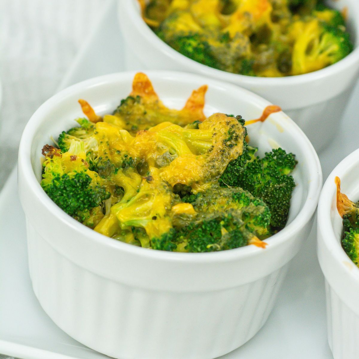 Broccoli cheese casseroles on a tray.