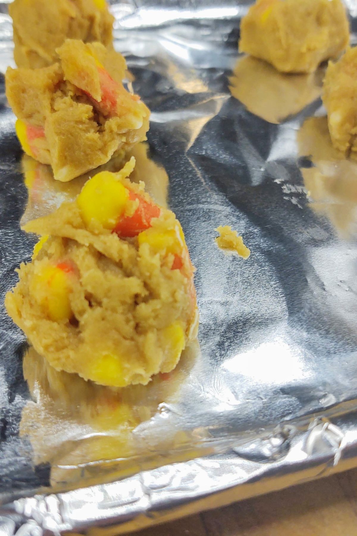 Balls of cookie dough on baking sheet.