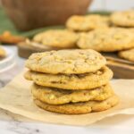 Stack of caramel apple cookies on brown paper.