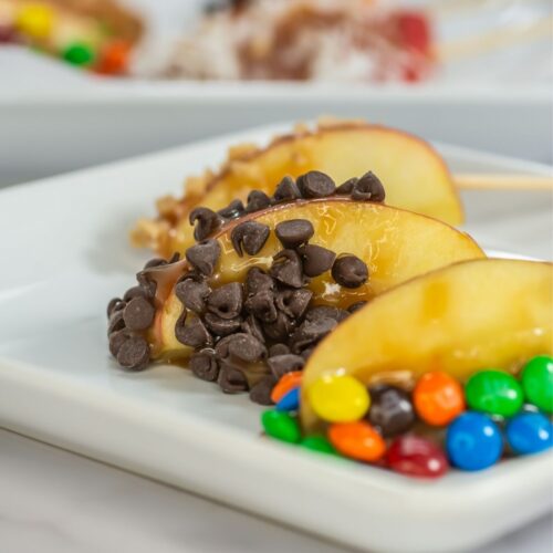 Caramel apple slices on a plate.