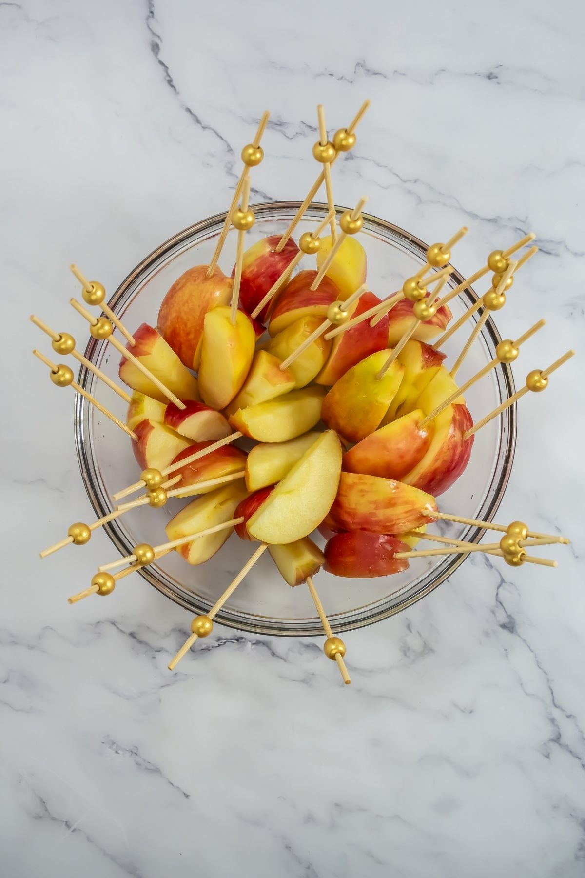 Sliced apples on toothpicks.