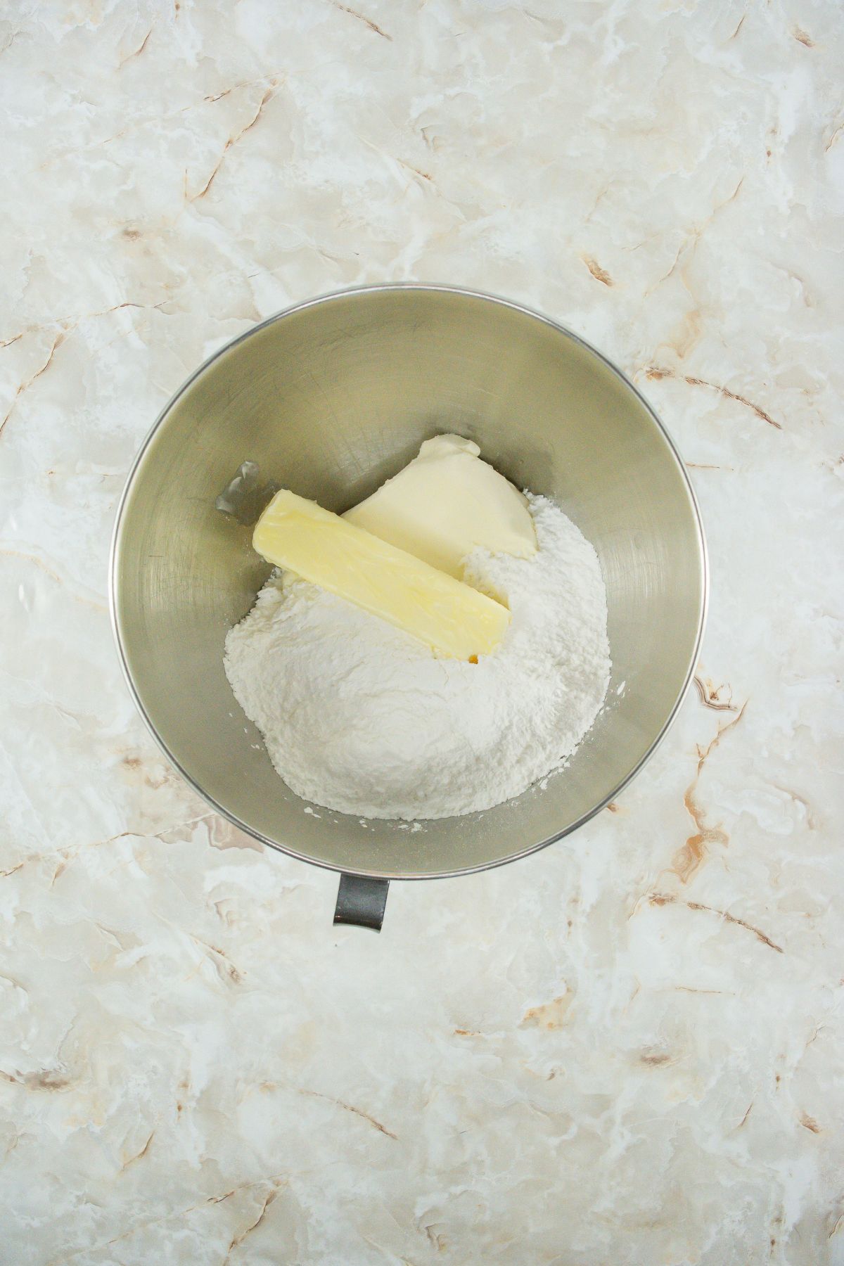 Powdered sugar and butter in bowl.