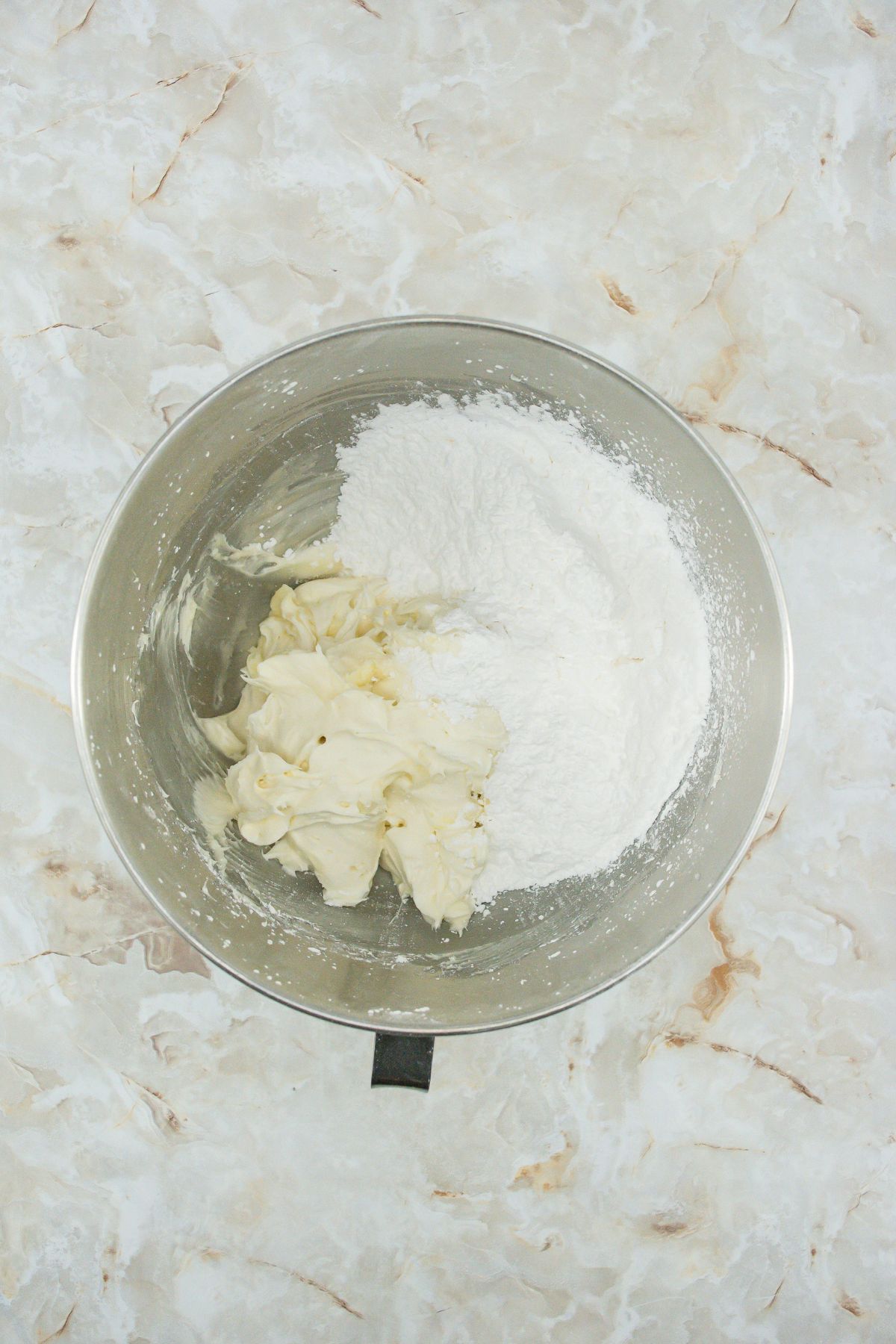 More powdered sugar added to bowl.