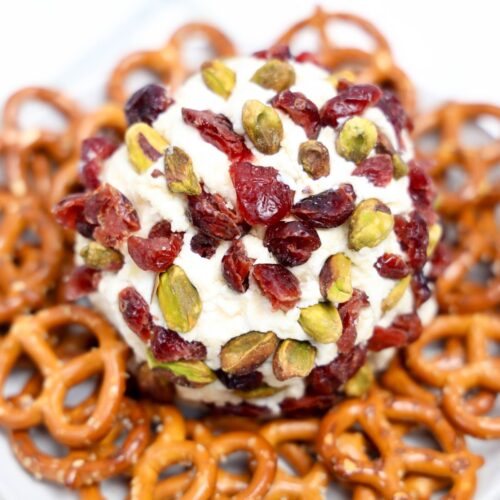 Cranberry parmesan cheeseball next to pretzels.