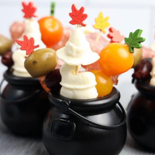 Cauldron charcuterie cups on a table.