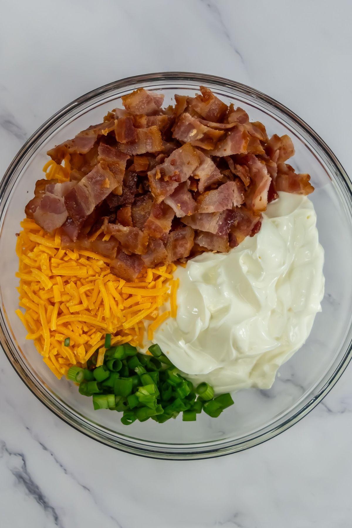 Baked potato dip ingredients in a bowl.