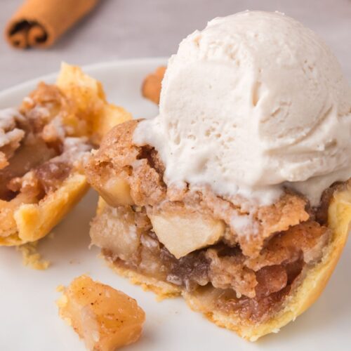 Mini apple pie tart topped with ice cream.