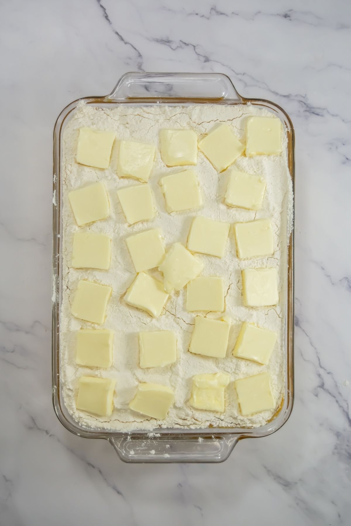 Sliced butter in baking dish.