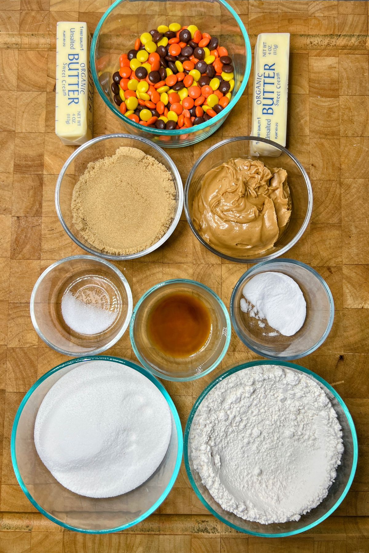 Reeses pieces cookie ingredients on wooden table.