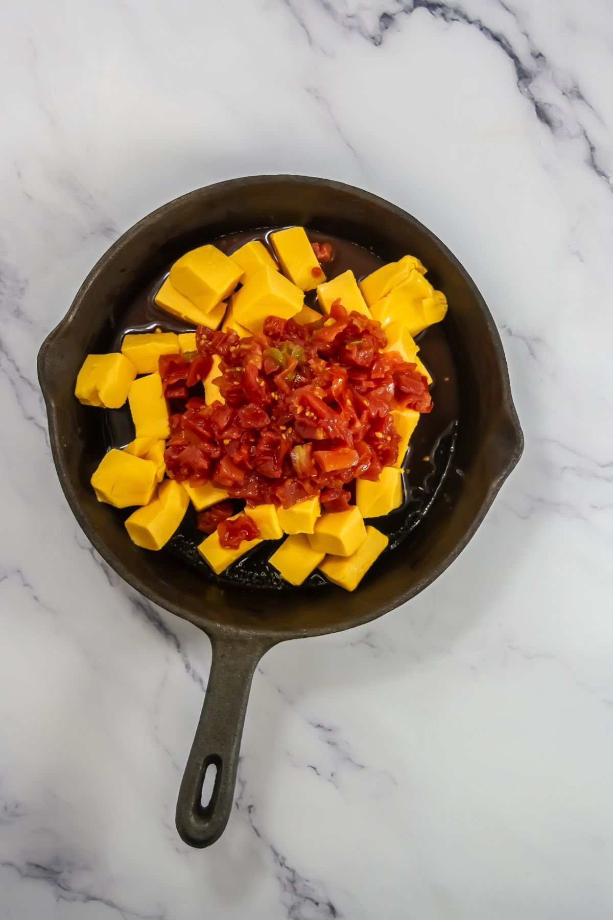 Velveeta and tomatoes in skillet.